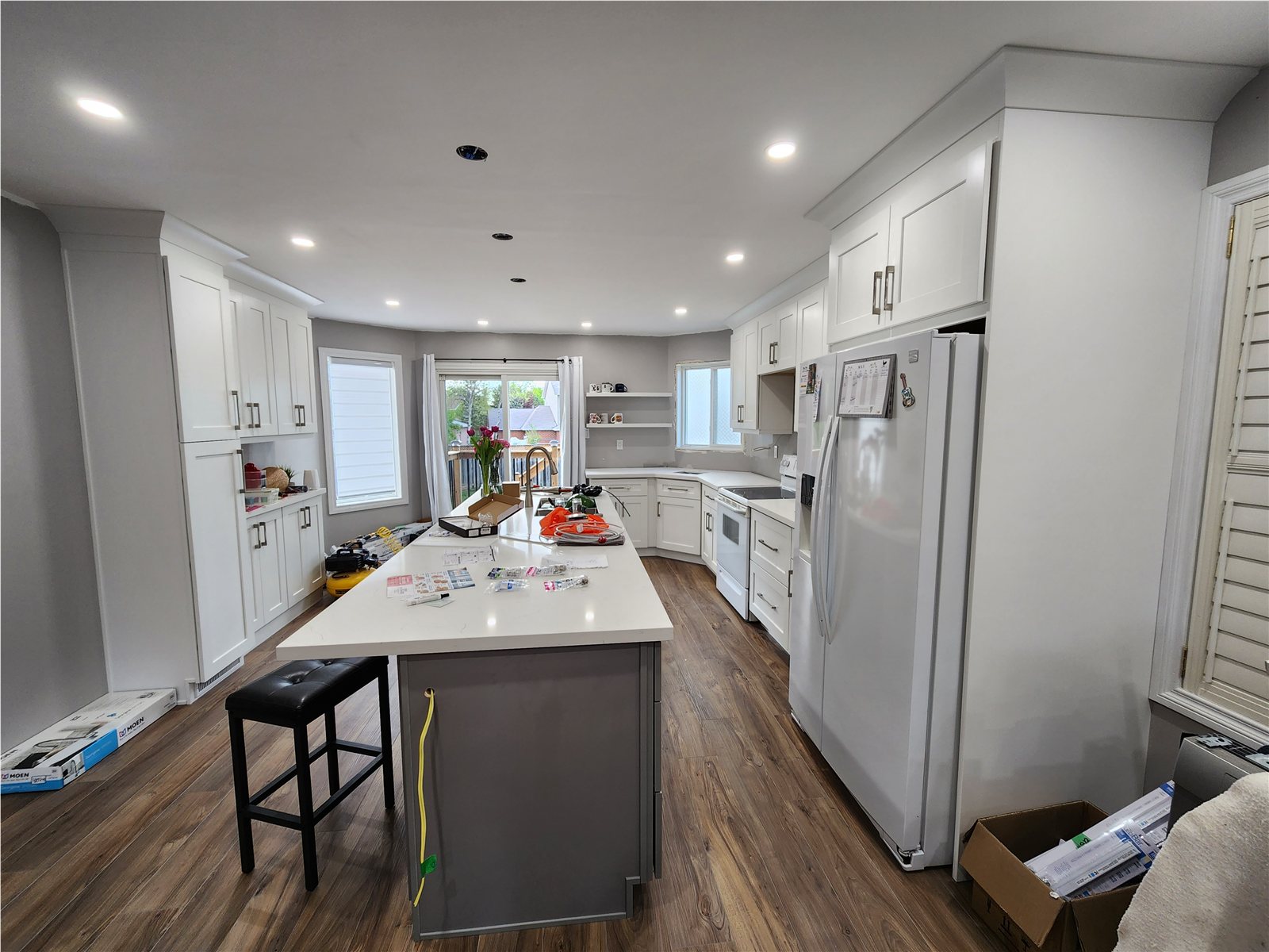 Keswick kitchen later with white shaker cabinets and a larger island
