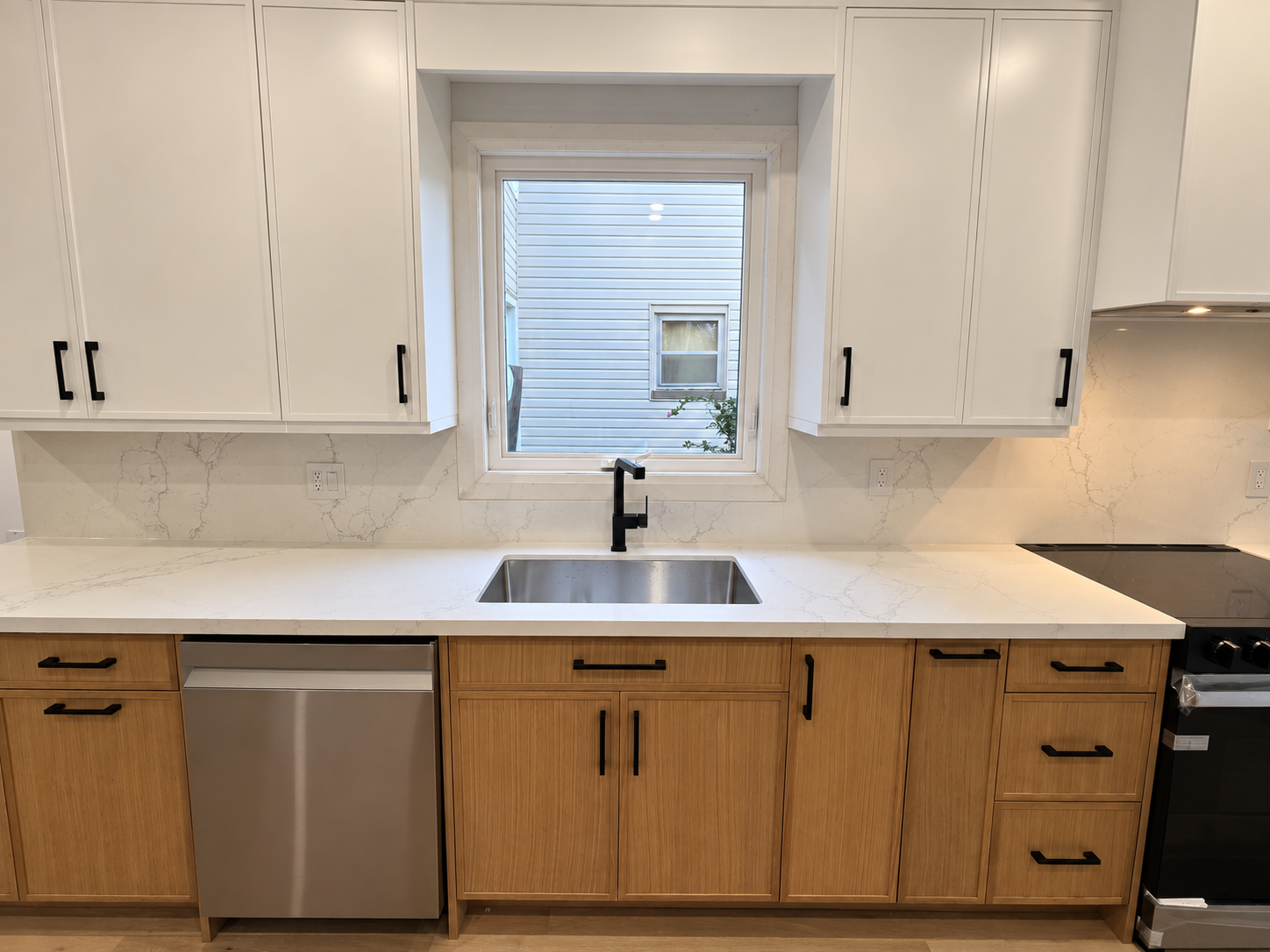 Toronto kitchen after update, showing light upper cabinets and dark lower cabinets